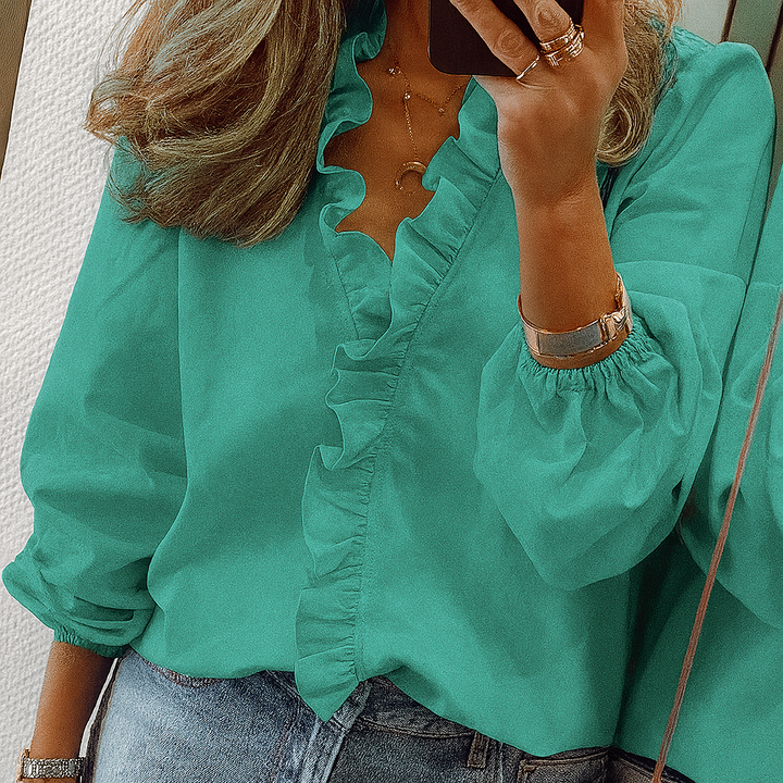 Blusa con volantes en color verde azulado y mangas abullonadas
